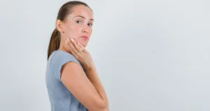 A woman applying skincare cream in natural lighting healthy and glowing skin 2025
