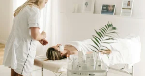 A woman applying skincare cream in natural lighting healthy and glowing skin 2025