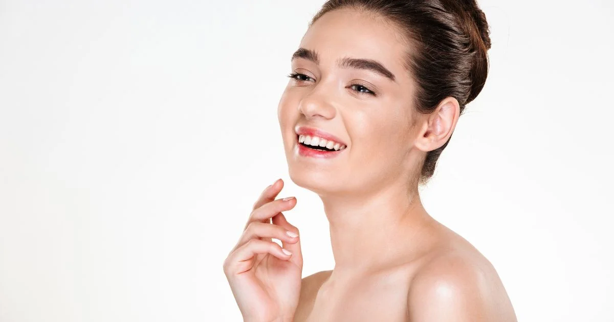 A woman applying skincare cream in natural lighting healthy and glowing skin 2025