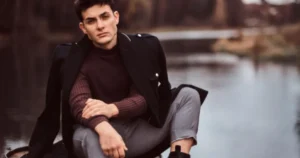Man dressed in casual dark academia style with blazer, sweater, and earthy tones